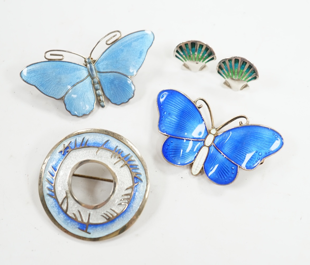 Two Scandinavian gilt white metal and enamel butterfly brooches, largest 52mm, together with a white metal and enamel circular brooch and a pair of earrings. Condition - fair to good